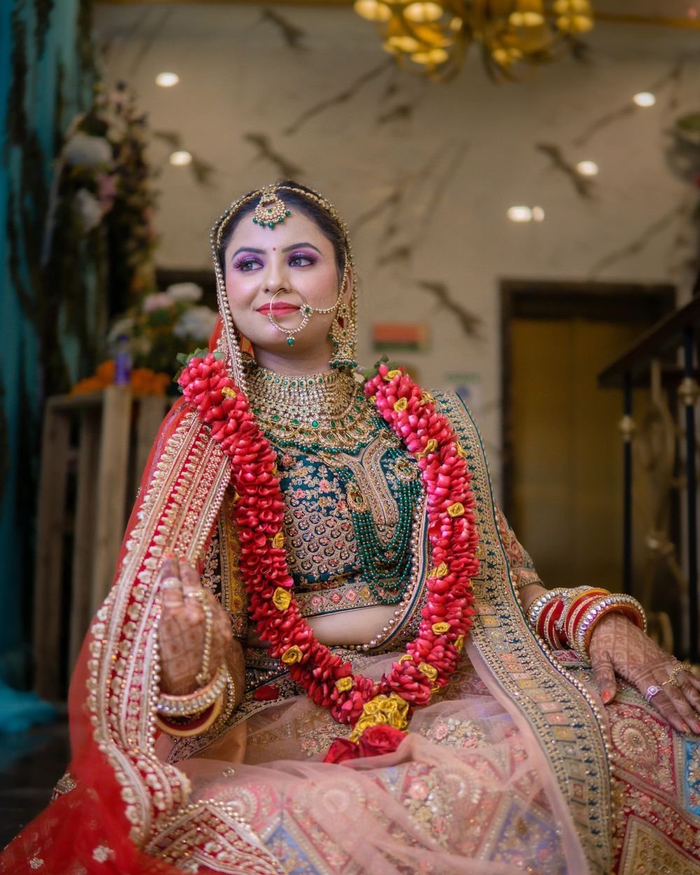 A bride in her wedding lehenga, photographed by Aurum Films Production